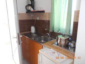 a small kitchen with a sink and a stove at Garifalia Studios in Kalamaki Heraklion