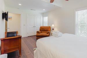 a bedroom with a bed and a chair and a desk at Sunsets At Joe's in St. George Island