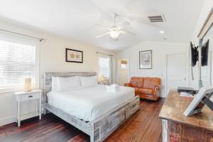a bedroom with a large bed and a chair at Sunsets At Joe's in St. George Island