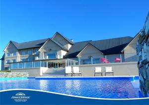 a swimming pool in front of a building at Howard Johnson Hotel Piedras Moras in Almafuerte
