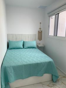 Posteľ alebo postele v izbe v ubytovaní Apartamento Casa Blanca