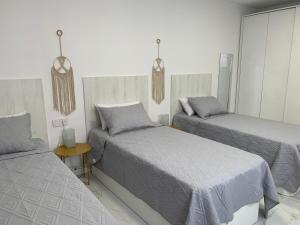 Posteľ alebo postele v izbe v ubytovaní Apartamento Casa Blanca