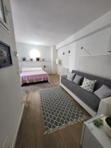 a bedroom with a white bed and white walls at Residenza Solferino in Corniglia