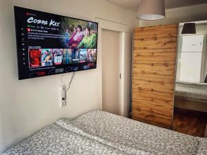 a bedroom with a flat screen tv on the wall at LUMA Apartment near Schönbrunn with parking in Vienna