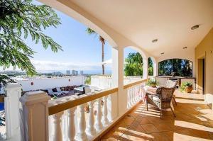 a balcony of a house with a view of the ocean at Villa with Private Pool, Jacuzzi & 360° Sea Views in Callao Salvaje