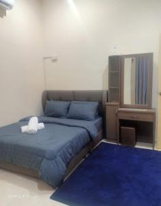a bedroom with a bed with a white stuffed animal on it at Melissa Homestay Merlimau in Merlimau