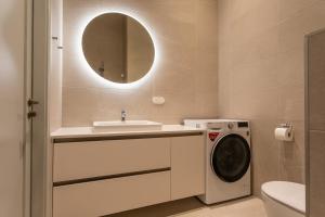 a bathroom with a washing machine and a sink at Vallikraavi Lux Apartment in Tartu