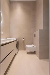 a bathroom with a toilet and a sink at Vallikraavi Lux Apartment in Tartu