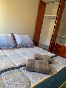 a bedroom with a bed with two towels on it at Departamento para 4 personas Constitución in Constitución