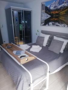 a large bed with a tray on top of it at R&M un moment de relaxation in Wardrecques