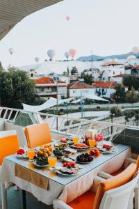 a table with plates of food and orange chairs at Kervansaray Hotel in Pamukkale