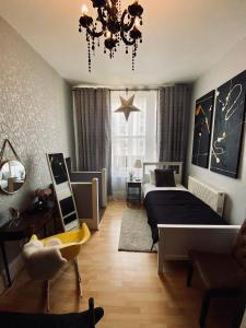 a bedroom with a bed and a chandelier at Ann Apartments opposite the Pier with sea view in Portsmouth