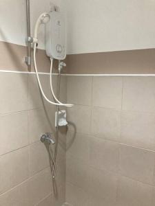 a shower with a shower head in a bathroom at 11F Migas Haven @ Sunvida Tower across SM City in Carreta