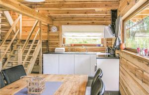 a kitchen and dining room in a tiny house at Amazing Home In Biskupiec With 2 Bedrooms in Biskupiec