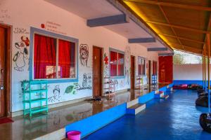 a room with graffiti on the walls of a building at HosteLife Gokarna in Gokarna