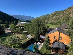 an aerial view of a house with a pool and mountains at El Cau de Cal Quimet in Rialp