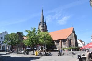 een grote kerk met een hoge toren op een straat bij fewo1846 - Stadtbude - komfortable 2-Zimmer-Wohnung mitten im Stadtzentrum in Flensburg