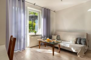 a living room with a couch and a table at SopotSpanie in Sopot