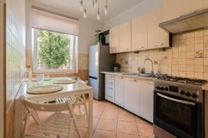 a kitchen with a table and a refrigerator at SopotSpanie in Sopot