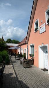 a building with chairs and tables in a courtyard at Kolpings-Gästehaus in Haselünne