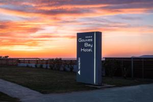 a sign for a hotel with the sunset in the background at Gouves Bay Hotel in Gouves