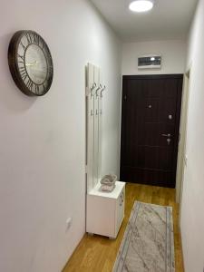 a room with a clock on the wall and a door at Apartment Marko in Budva