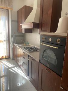 a kitchen with a black stove top oven in it at Appartamento Mire&Geo in Voghera