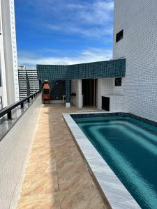 a swimming pool on the roof of a building at Puerto de Villas in Recife