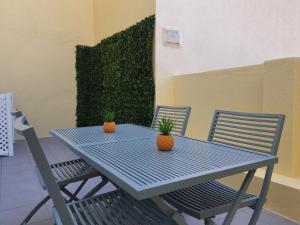 a blue table and chairs with two plants on it at Exotic Fusion: Coffee & Radio in Lisbon +7 photos