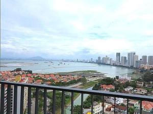 a view of the ocean from a balcony of a city at 皇家海景ROYAL Luxury Seaview Room, 3 minute to Gurney in Tanjong Tokong