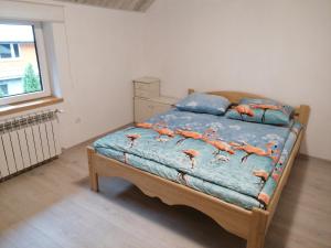 a bedroom with a bed with orange shrimp on it at Osada leśna in Sztabin