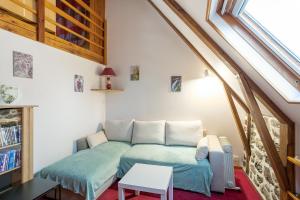 a living room with a couch and a window at Gite Les Marmottes in Trémouille