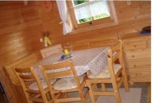 a dining room table and chairs in a cabin at Ferienhaus Schlagintweit in Drachselsried