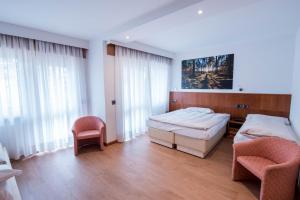 Postel nebo postele na pokoji v ubytování Hotel Moena