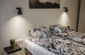 um quarto com uma cama com almofadas em Rozenstein design apartment em Brocēni