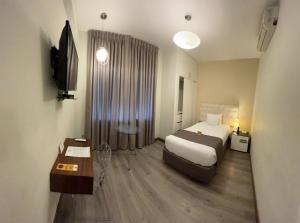 Postel nebo postele na pokoji v ubytování LimaQ Hotel