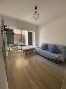 a living room with a couch and a table at Cœur de ville au 1er 66M2, vu sur la place in Gap