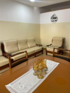 a living room with a table with glasses on it at Apartamentos Avenida in Praia