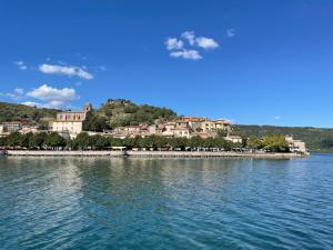 a small island in the middle of a body of water at Casa Vacanze Lago Blu in Trevignano Romano