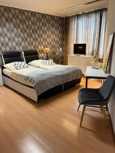 a bedroom with a bed and a desk and a chair at Ferienwohnung mit Whrpool in Koblenz