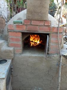 a brick oven with a fire inside of it at Eco Hotel Banderas in Huaraz