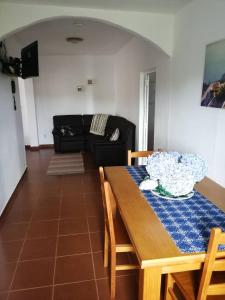 a living room with a table and a couch at Casa do Lajedo in Porto Martins +7 photos