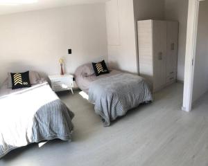 ein Schlafzimmer mit zwei Betten und einer Kommode in der Unterkunft Olivo Apartment in Esquel