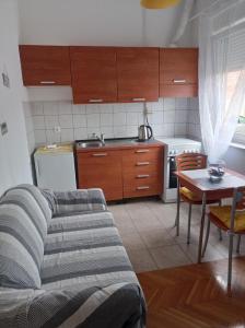 a kitchen with a couch and a table in a room at Donata in Osijek