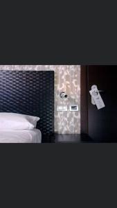 a bedroom with a bed and a door with a tag at MH Design Hotel in Naples