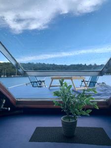 łódź z dwoma stołami i doniczką w obiekcie Traditional 2 bedroom houseboat Nova Natalina w mieście Brovinje