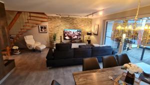 sala de estar con sofá y mesa en Luxusferienhaus Seevilla Monaco am Fleesensee, en Göhren-Lebbin