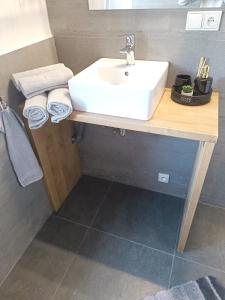 a bathroom with a sink and a counter with towels at Zoo Karlovarská Apartment in Pilsen