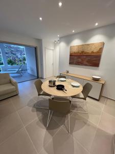 a dining room with a table and chairs and a couch at Cozy apartment with pools in Palm Mar in Palm-Mar