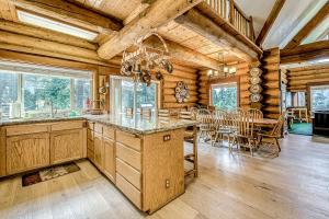 a kitchen and dining room with a table and chairs at Regatta Chalet in Lakeshore